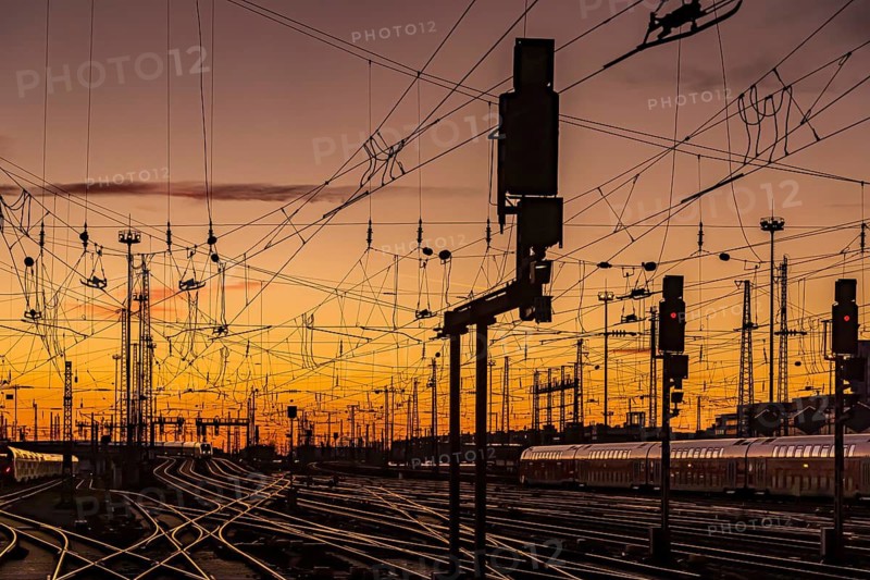 Track apron with trains, rails, points, pylons and signalling systems. Infrastructure at the main station. Sunset. Frankfurt am Main, Hesse, Germany