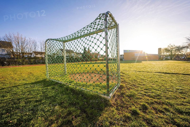 Sports field with soccer goal on a sunny spring morning, Schlehengäuschule, Gechingen, Hecken and Gäu region, Calw district, Germany