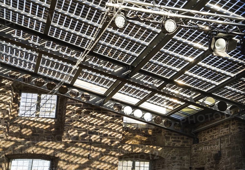 Old castle with modern photovoltaic system as the roof of the concert hall, Wülmersen moated castle, Trendelburg, Hesse, Germany