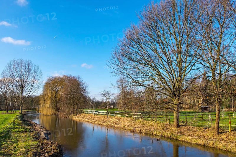 River Dinkel, trees without leaves, blue sky, peaceful rural scene, Heek-Nienborg, Münsterland, North Rhine-Westphalia, Germany