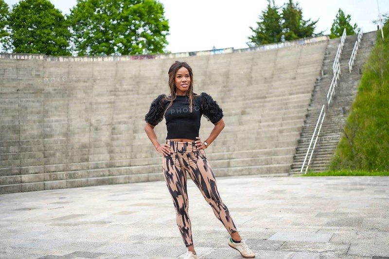 Latin dancer standing alone in a park about to dance salsa