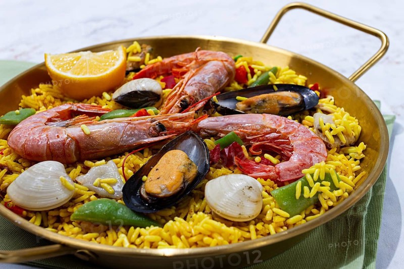 Seafood paella, shrimp and mussel risotto, rice, paella in a pan, homemade, natural light, top view, no people