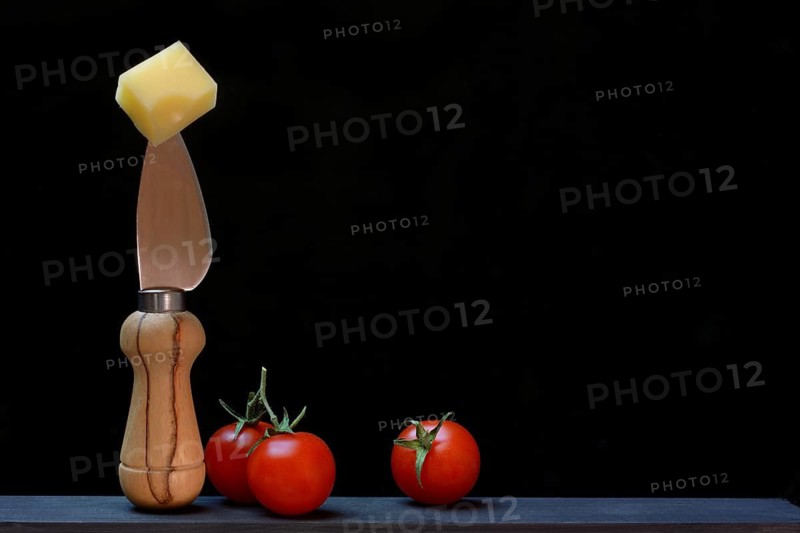 A piece of Swiss Emmental cheese on a cheese knife