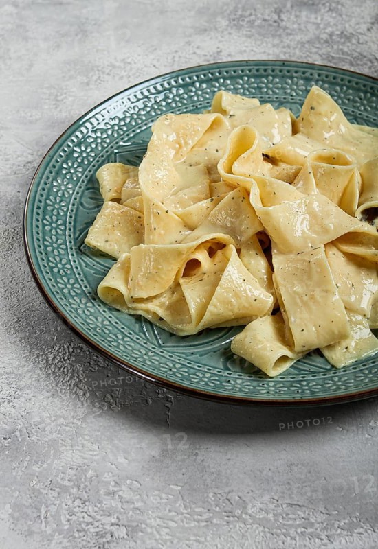 Pasta papardelle in creamy garlic sauce, traditional Italian cuisine, pasta carbonara, homemade, no people