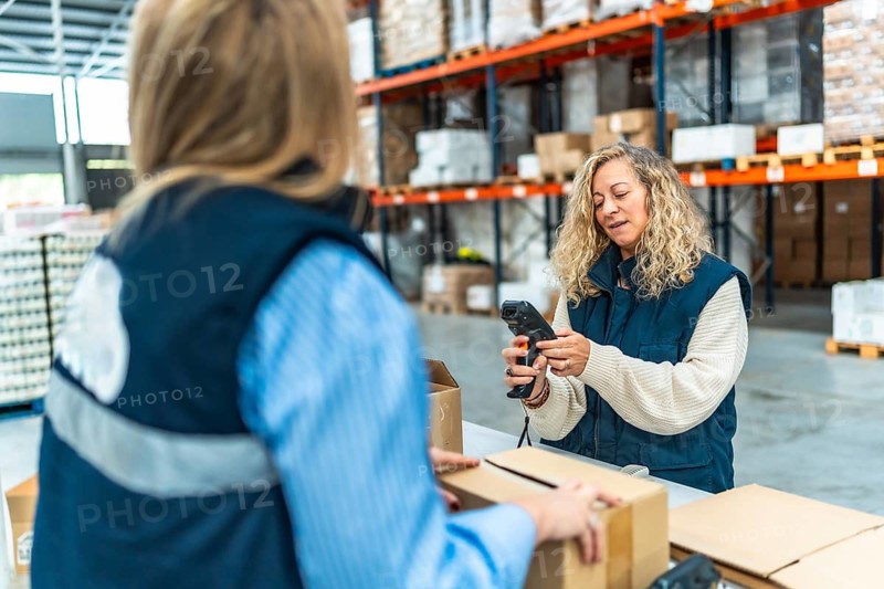 Distribution warehouse female caucasian workers preparing parcels to deliver
