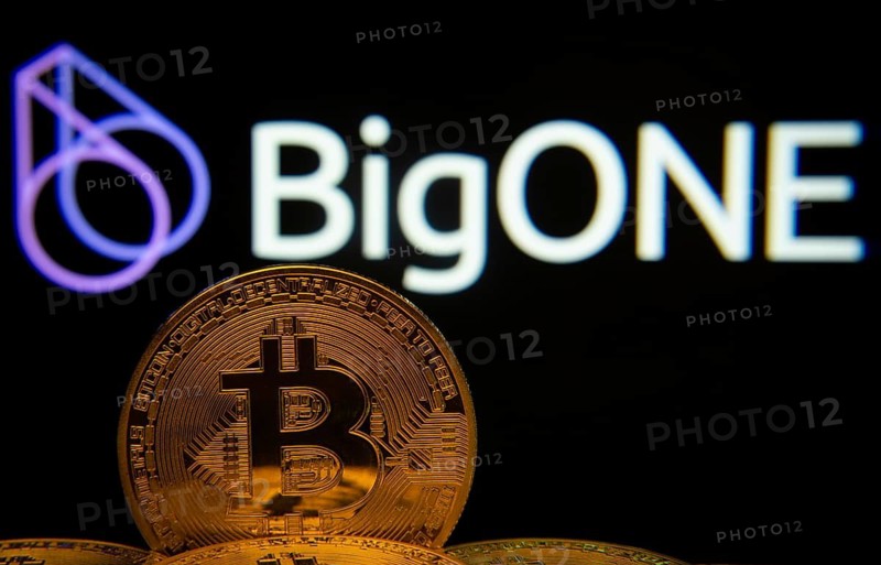 Dhaka, Bangladesh- 15 June 2025: Close-up of Bitcoin coins with the bigONE logo visible on a screen in the background