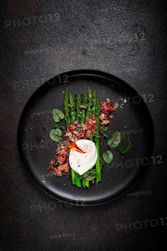 Asparagus with poached egg and fried bacon, micro greens and spices, breakfast, homemade, no people