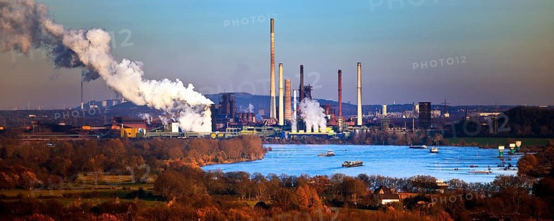 View from the Rheinpreussen spoil tip to Duisburg with ships on the Rhine and the Thyssen Krupp plant in Bruckhausen, Ruhr area, Germany