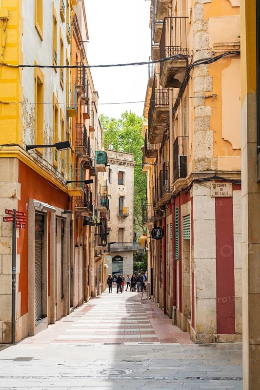Narrow streets with shops in the city centre of Figueras, Spain