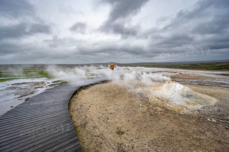 Tourist on a wooden path, steaming fumarole, Hveravellir geothermal area, Icelandic highlands, Suðurland, Iceland