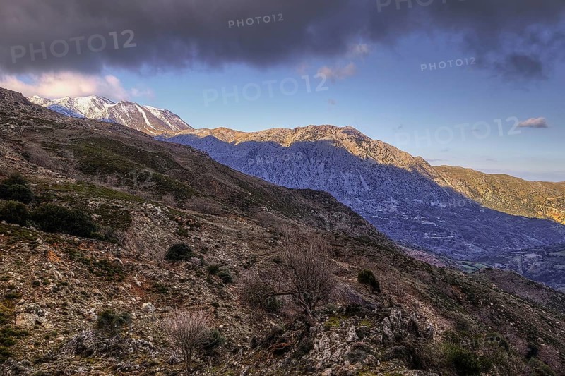 Stony mountain landscape with snow-covered peaks under a slightly cloudy sky, Lefka Ori, White Mountains, mountain massif, West, Crete, Greece