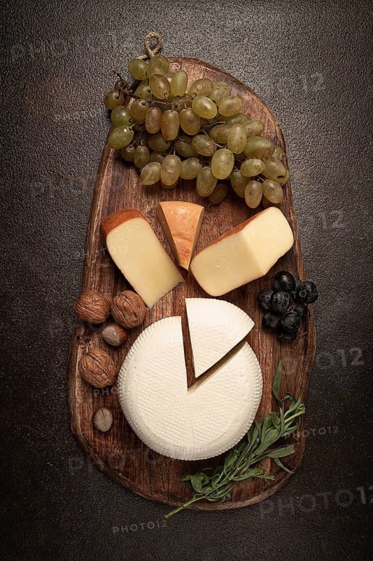 Georgian cheese, Imeretian and smoked suluguni, grapes, nuts, on a cutting board, Georgian cuisine, no people