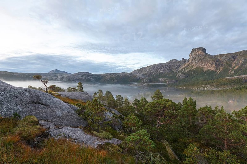 Magical morning fog on Steigtindvatnet in front of the majestic Steigtinden in Norway near Bodø