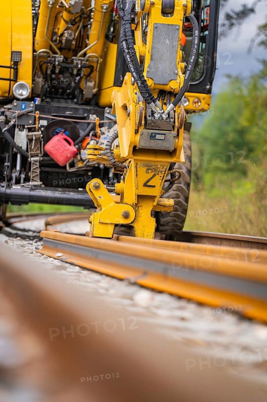 Close-up of a yellow construction machine working on a rail, track construction, Hermann Hessebahn, Calw, Black Forest, Germany