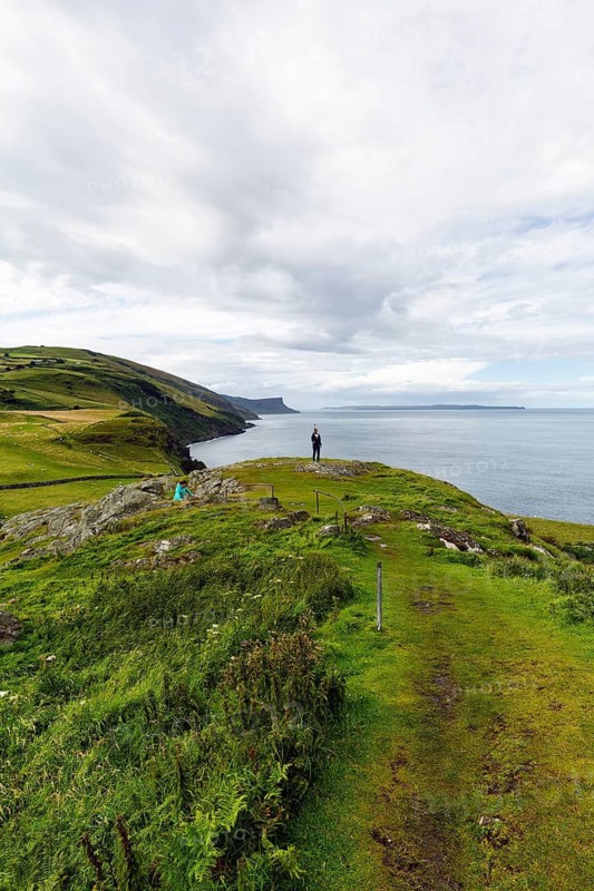 Walkers on footpath, coastline between Ballycastle and Ballintoy, viewpoint, Causeway Coastal Route, Antrim, Northern Ireland, Great Britain