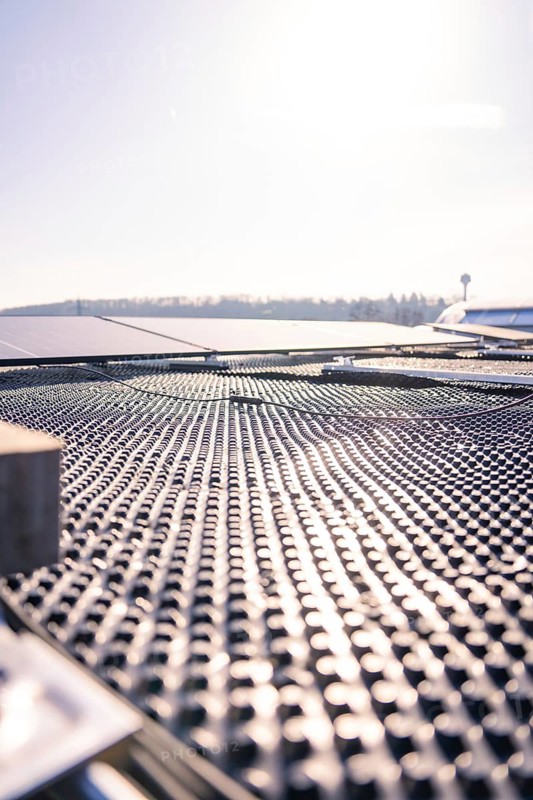 Detailed view of the structured surface of a solar roof in sunshine, PV installation at OBI Baumarkt, Mühlacker, Enzkreis, Germany