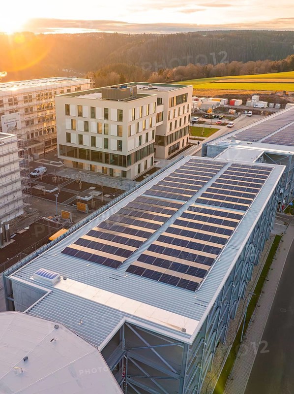 Modern architecture with solar panels and office building in the sunset, new Calw health campus, Calw district, Black Forest, Germany