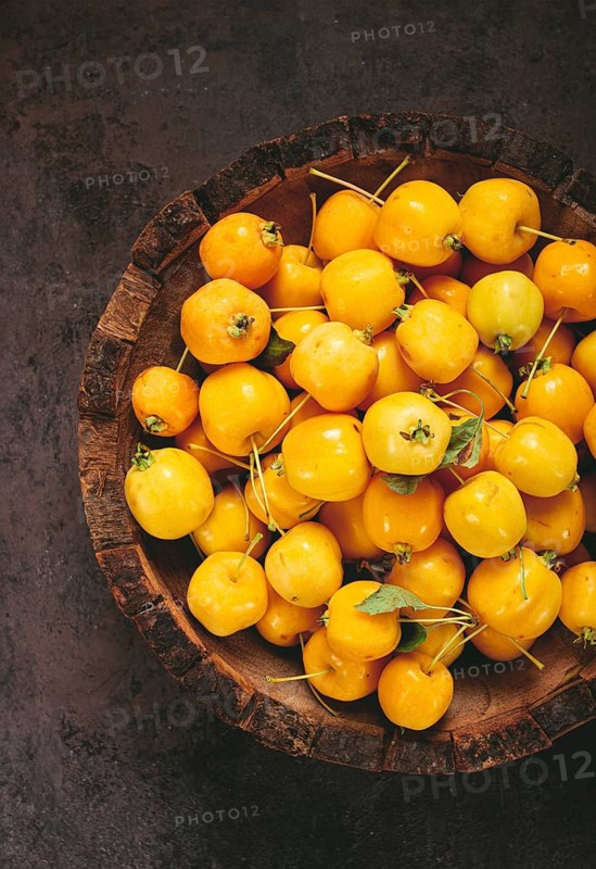 Yellow small apples, Chinese varieties, in a wooden bowl, top view, no people