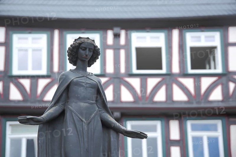 Sculpture of Saint Barabara, patron saint of miners, half-timbered fountain house, monochrome, gray, black and white, Eisenmarkt, Wetzlar, Hesse, Germany