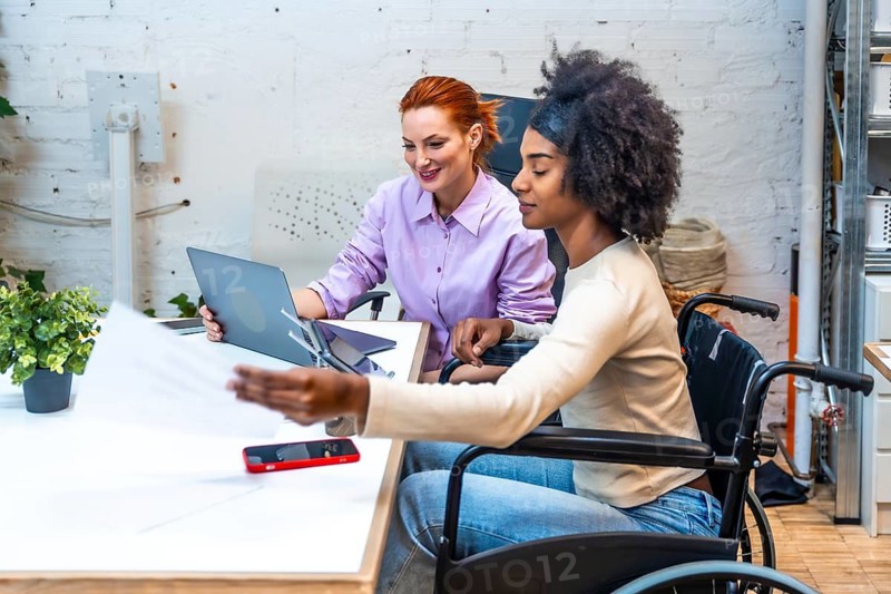 Diverse female colleagues working together in a meeting room in a coworking
