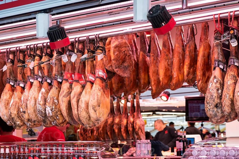 Market stall with sausage products at La Boqueria Market in Barcelona, Spain