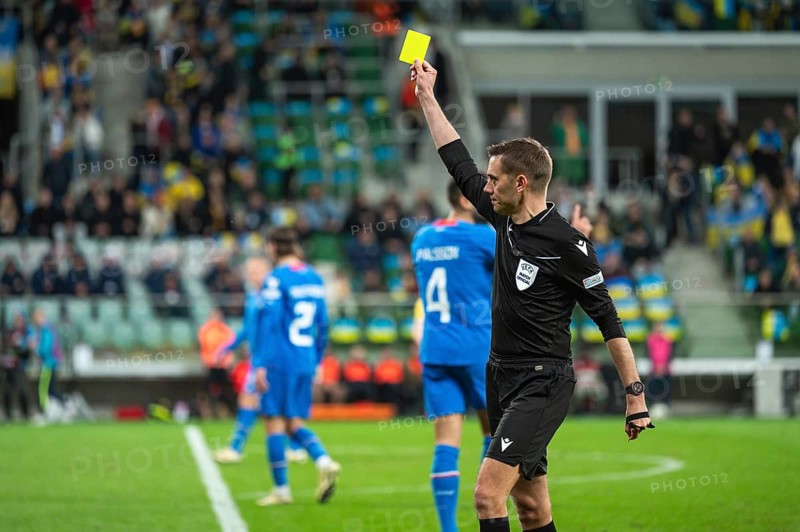 WROCLAW, POLAND - MARCH 26, 2024: Qualifications for UEFA Euro 2024. Final play-off match Ukraine - Iceland 2:1. Main referee Clement Turpin shows yellow card.