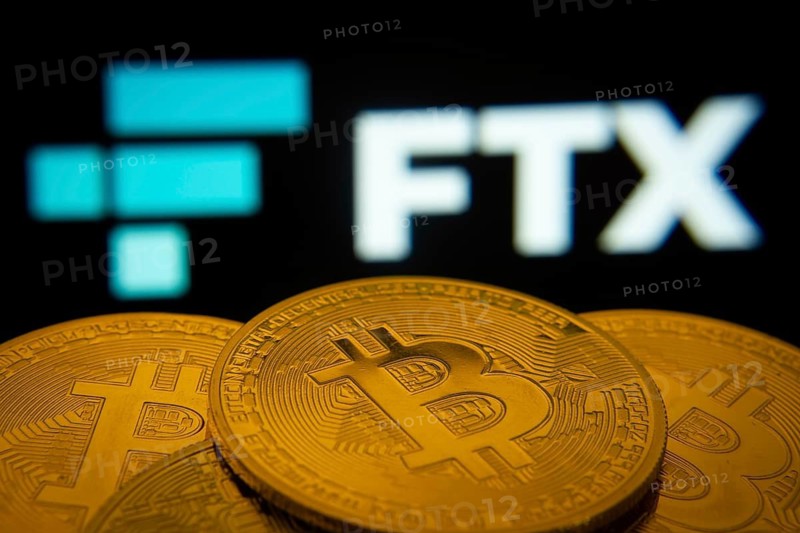 Dhaka, Bangladesh- 03 Sep 2025: Close-up of Bitcoin coins with the FTX logo visible on a screen in the background
