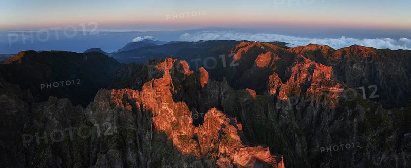 Aerial drone panorama view of Pico do Arieiro and mountains over clouds on sunset. Above Pico Ruivo, Madeira island, Portugal