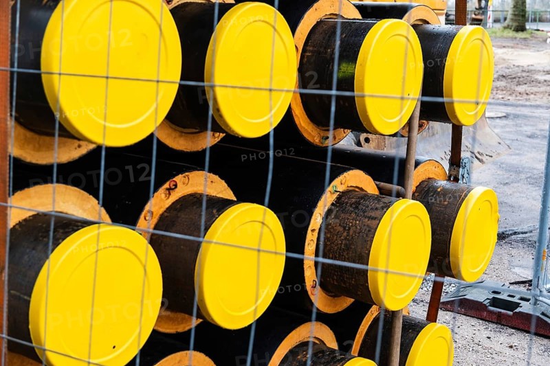 A stack of new pipes for a district heating pipeline on a construction site in Düsseldorf, Germany