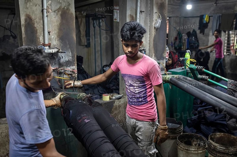 Worker in a denim dyeing factory, textile industry, Dhaka, Bangladesh