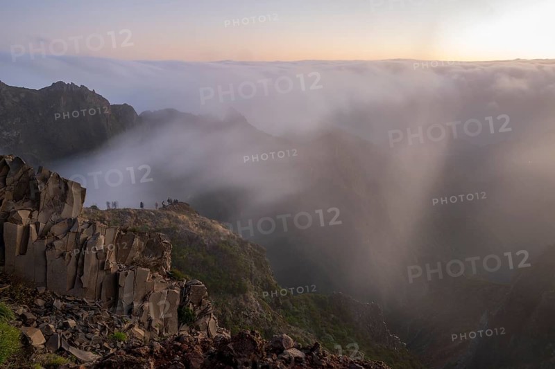 Sunrise at Pico do Arieiro, clouds of fog pass over mountain peaks, hiking trail PR1, Madeira, Portugal