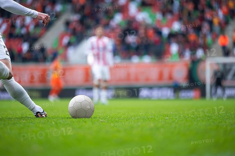 Detail of player's legs and the ball during soccer match