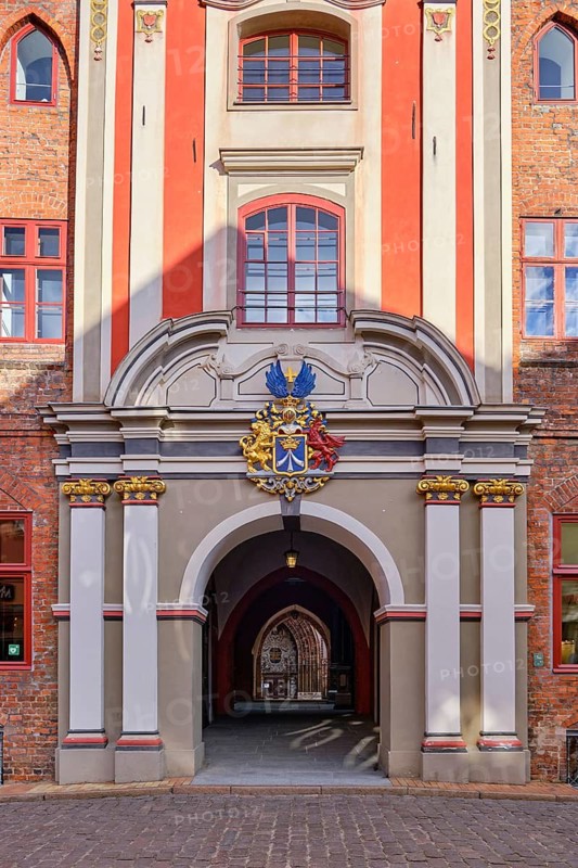 Baroque grand portal with city coat of arms from the Swedish occupation period on the west side of the town hall, which leads via the so-called butter aisle to the west portal of St. Nicholas Church, Hanseatic City of Stralsund, Mecklenburg, Western Pomerania