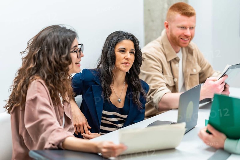 Business team analyzing documents and discussing strategy during a productive meeting in the office
