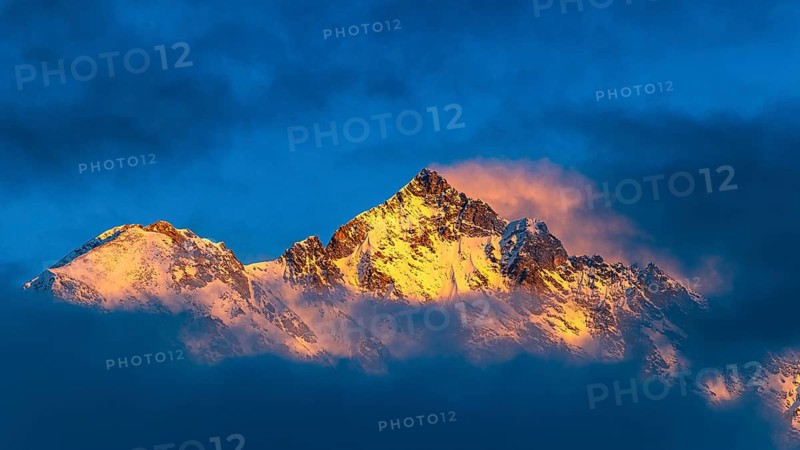 Snow-covered summit of the Weisshorn mountain, illuminated by the evening sun, view from Grimentz, Val d'Anniviers, Valais Alps, Canton Valais, Switzerland