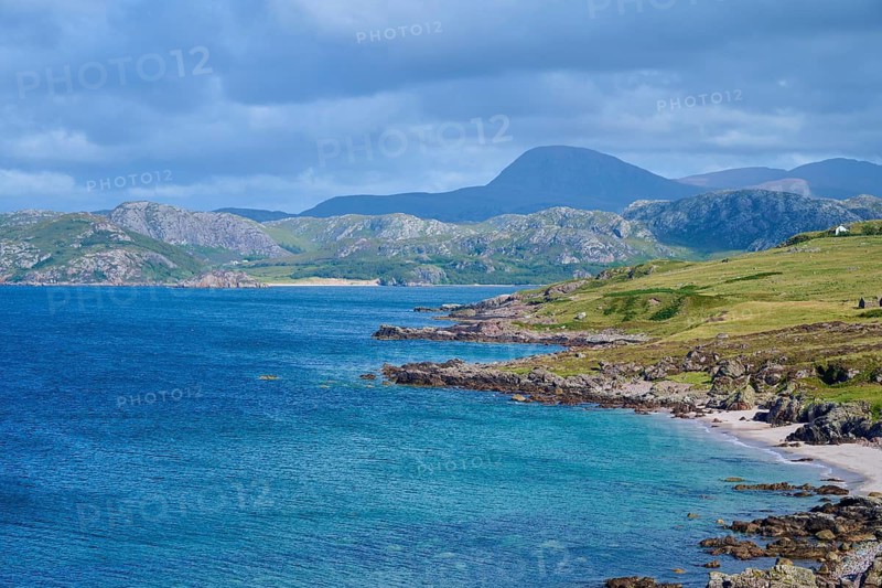 Rocks and hills form a picturesque coastline under a cloudy sky, Gruinard Beach, First Coast, Little Gruinard, Achnasheen, Scotland, United Kingdom, Great Britain