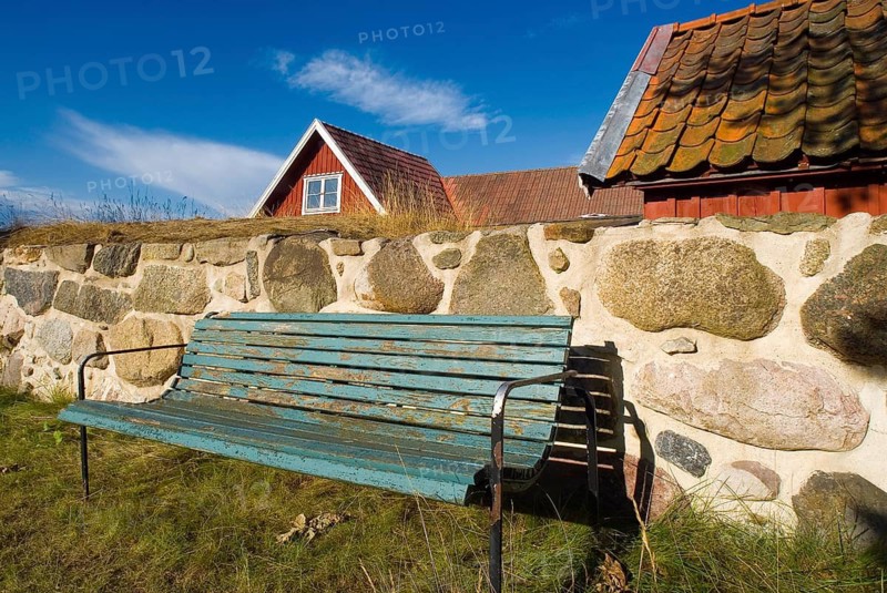 Park bench, bench, wooden bench in front of a wooden house in Karlskrona, Sweden
