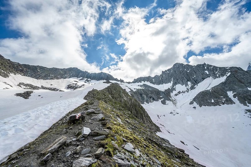 Hiking trail between large snowfields, ascent to the Schönbichler Horn, Berliner Höhenweg, Zillertal Alps, Tyrol, Austria