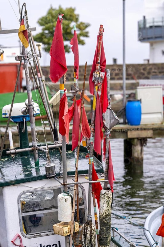 Fishing boats in the town harbour of Sassnitz, island of Rügen, marker buoys for the nets, with red flags, Mecklenburg-Western Pomerania, Germany