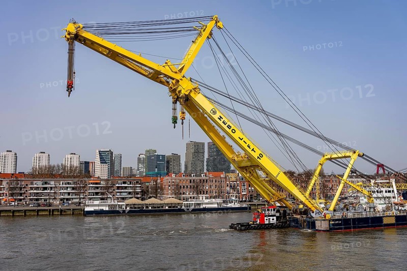 The Hebo Lift 10, supposedly the strongest crane ship in Europe, sails from the Rotterdam inland port to the Nieuwe Maas, through the flap bridge of the Erasmus Bridge, up to 2200 tons of lifting capacity, here in front of the Noordereiland district, the Netherlands