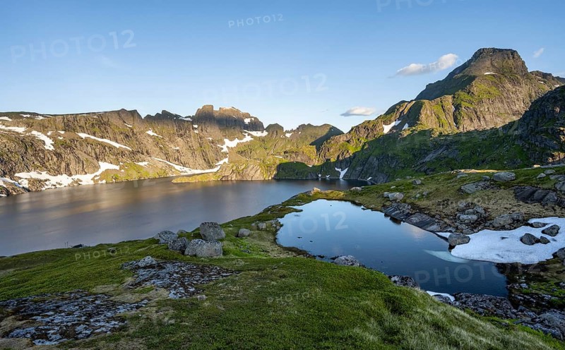Mountain landscape with lake Krokvatnet, in the back mountain peak Helvetestinden, at sunrise, Moskenesøya, Lofoten, Nordland, Norway