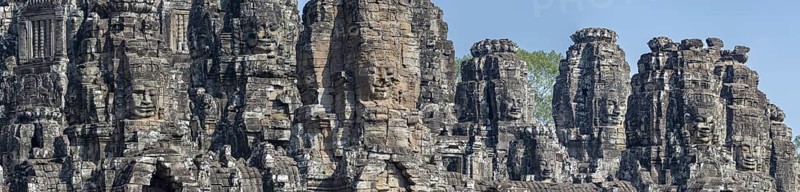 Panoramic image of giant stone-carved faces of the Bodhisattva Lokeshvara, also known as Avalokiteshvara, Bayon Temple, Angkor Thom, UNESCO World Heritage Site, Angkor Wat, Siem Reap, Cambodia