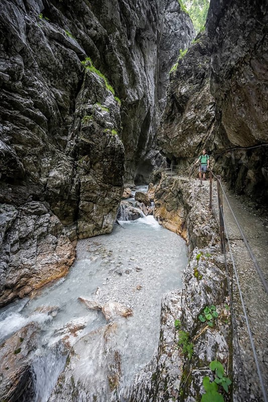 Hammersbach mountain stream in a canyon, mountaineer on a hiking trail in a gorge, Höllentalklamm, Höllental, Bavaria, Germany