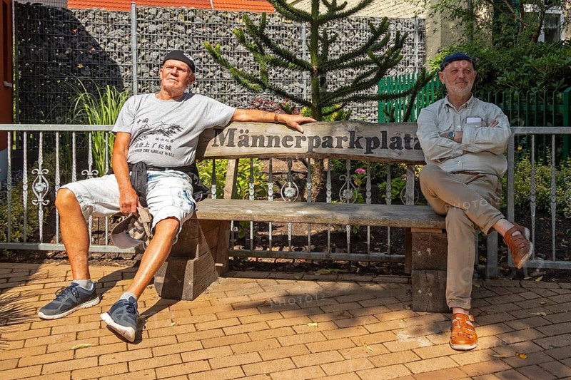 Two elderly men sitting on a bench, men's car park, Wustrow, Darß, Mecklenburg-Vorpommern, Germany