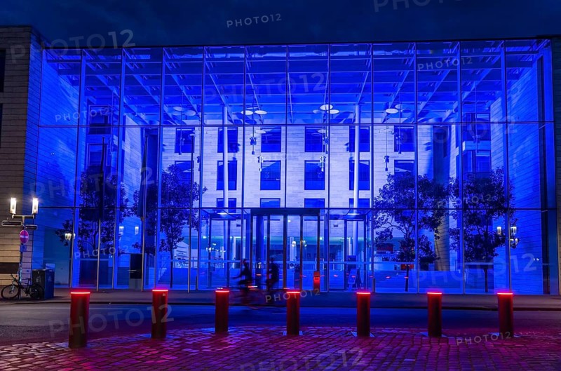 Historic old town, blue illuminated building of the Münster district government, illuminated barrier, bollards, in Münster, North Rhine-Westphalia, Germany