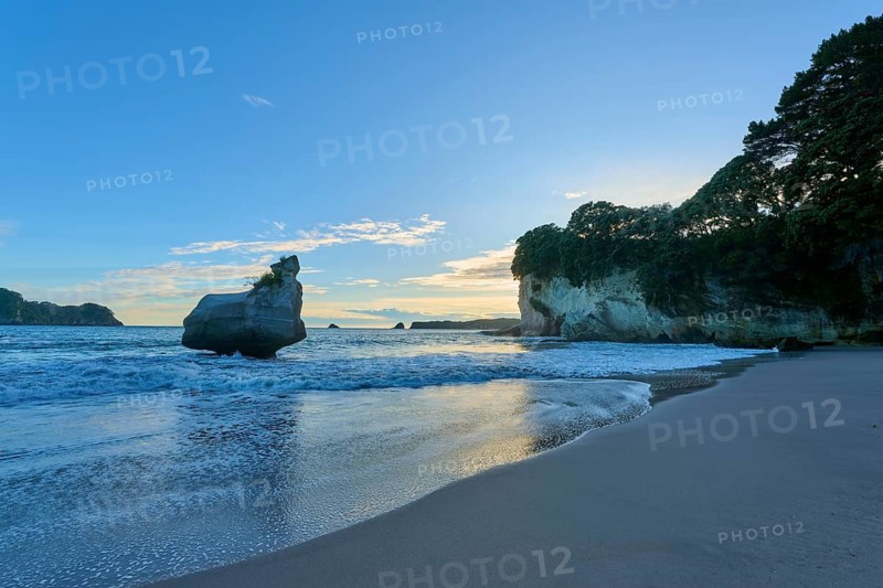 Beautiful beach scene at sunrise, with calm sea and large rocks on the coast, Cathedral Cove, Coromandel, Canterbury, North Island, New Zealand