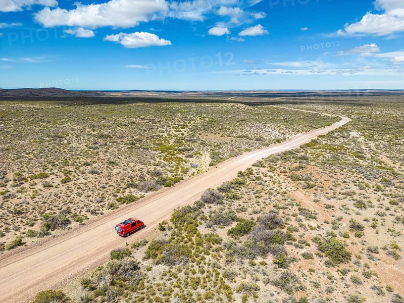 4x4 campervan drives along the road near Estancia la Maciega, Chubut, Argentina