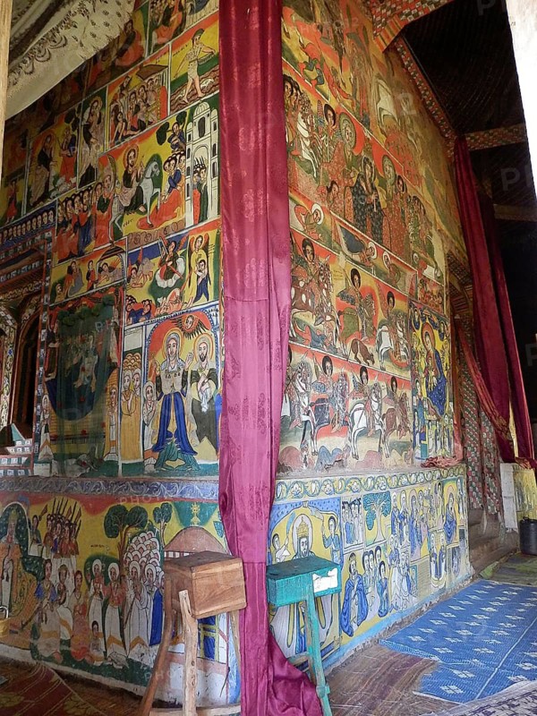 Wall paintings depicting religious scenes in an orthodox church, vivid colors create a spiritual atmosphere, Ethiopia
