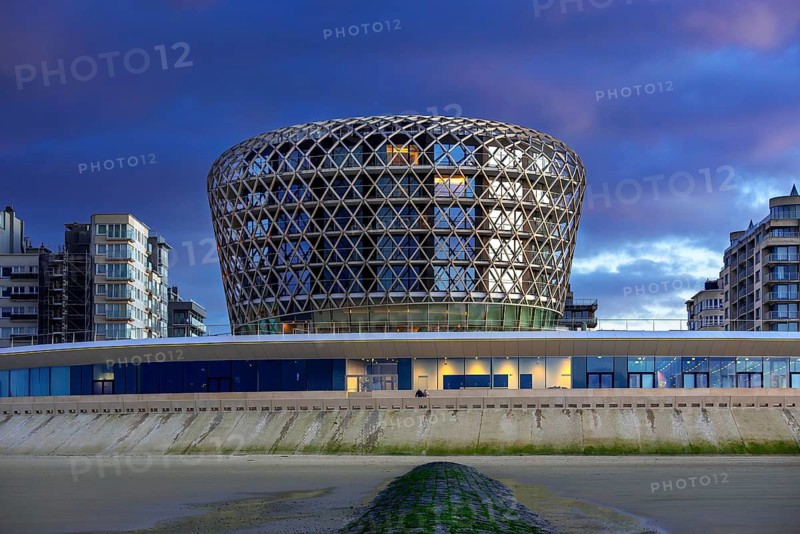 SILT casino, hotel and restaurant in seaside resort Middelkerke seen from beach along the North Sea coast illuminated at dusk, West Flanders, Belgium