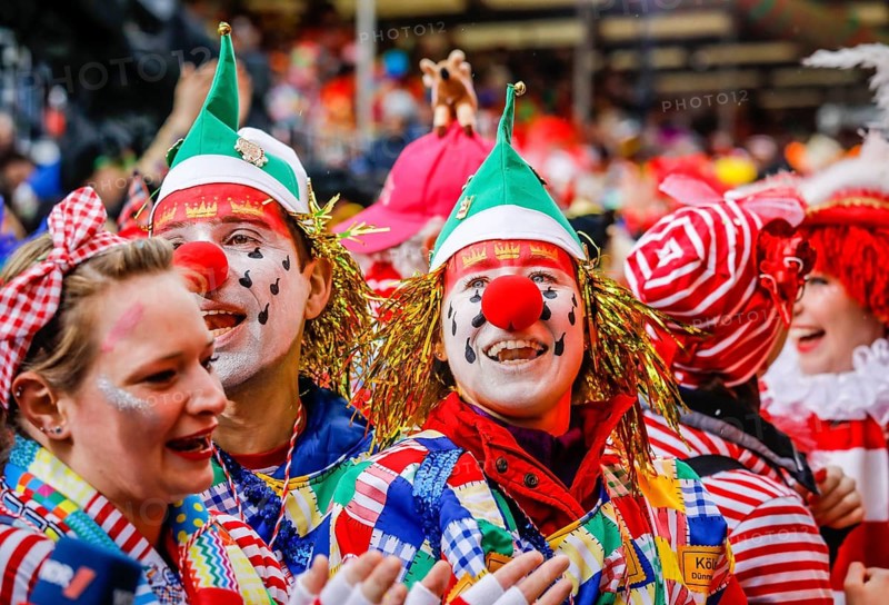 Colourfully costumed carnivalists celebrate carnival in Cologne, on Weiberfastnacht the street carnival is traditionally opened on the Alter Markt, which then reaches its climax on Rosenmontag, Cologne, Rhineland, North Rhine-Westphalia, Germany